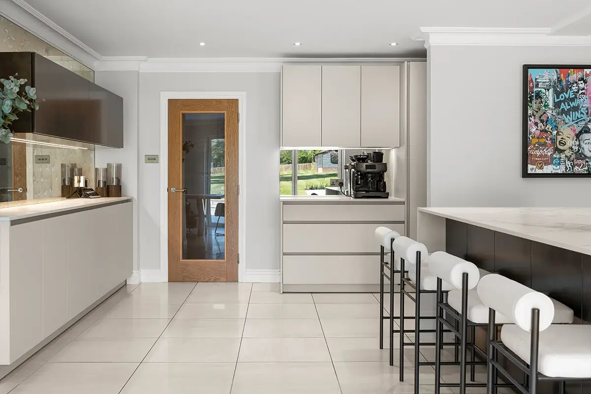 Contemporary kitchen with pale floor tiles, tall cabinets and a dark wood island