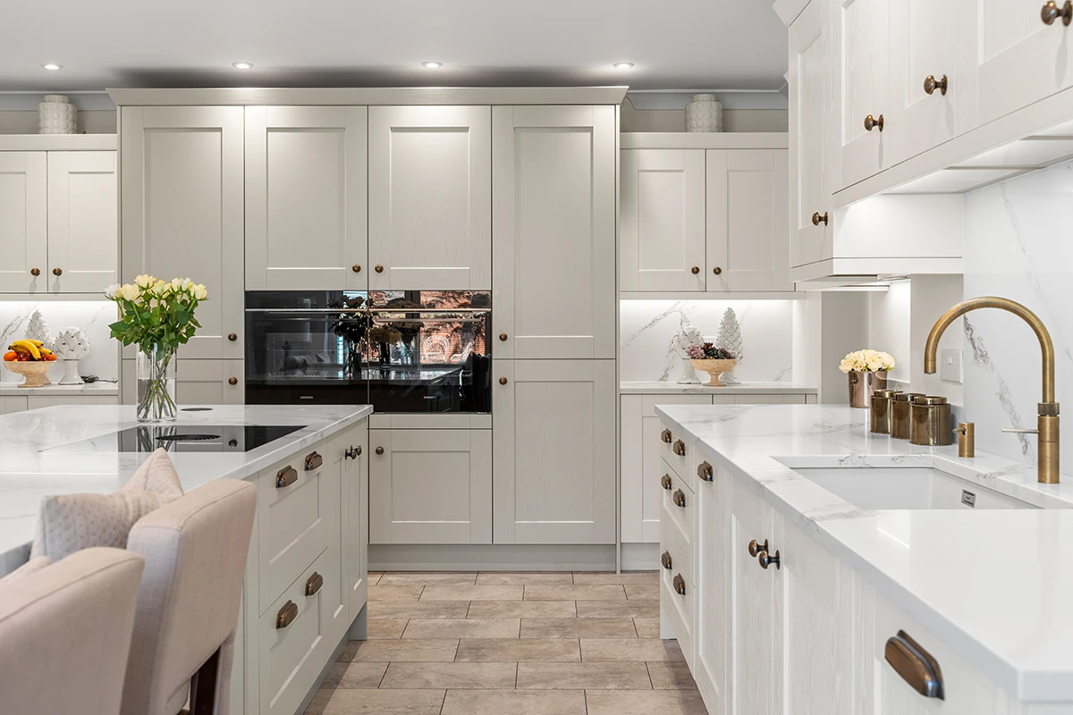 Traditional light-coloured kitchen with twin worktop runs and built-in ovens